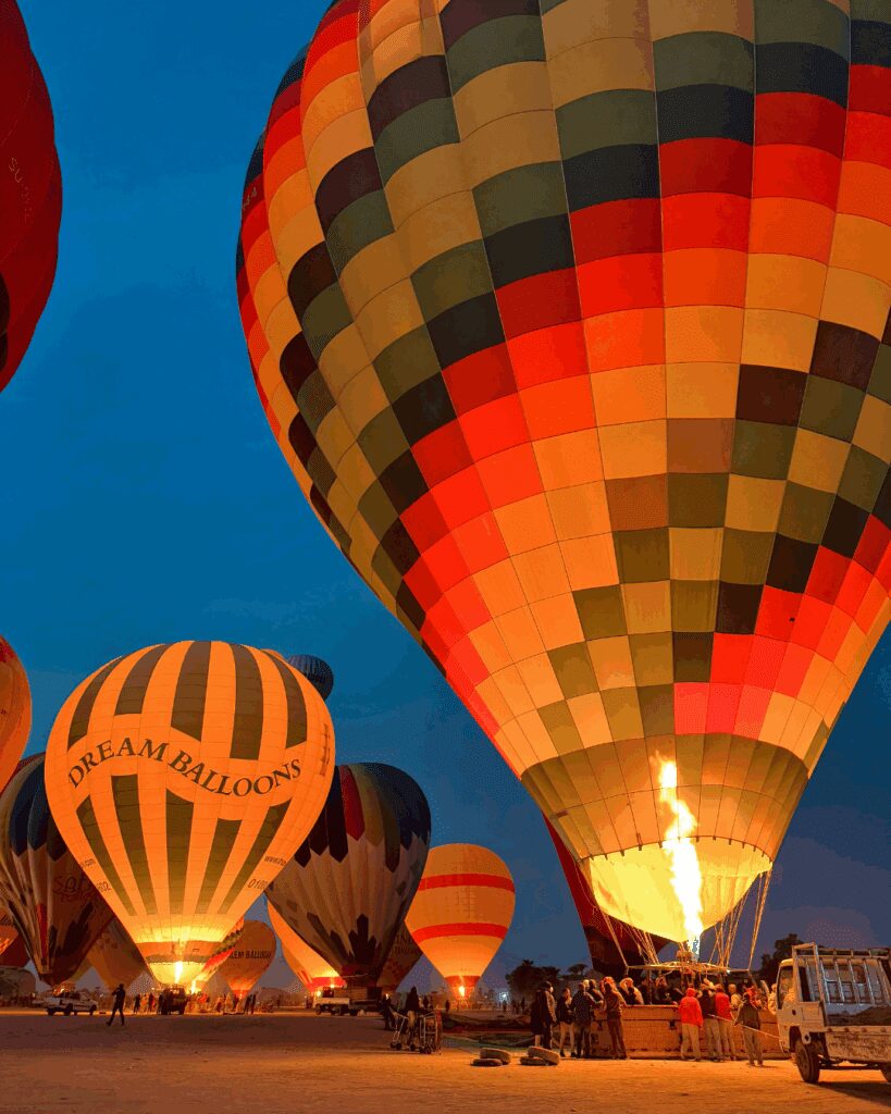 Colorful hot air balloons preparing for sunrise flight in Marrakech