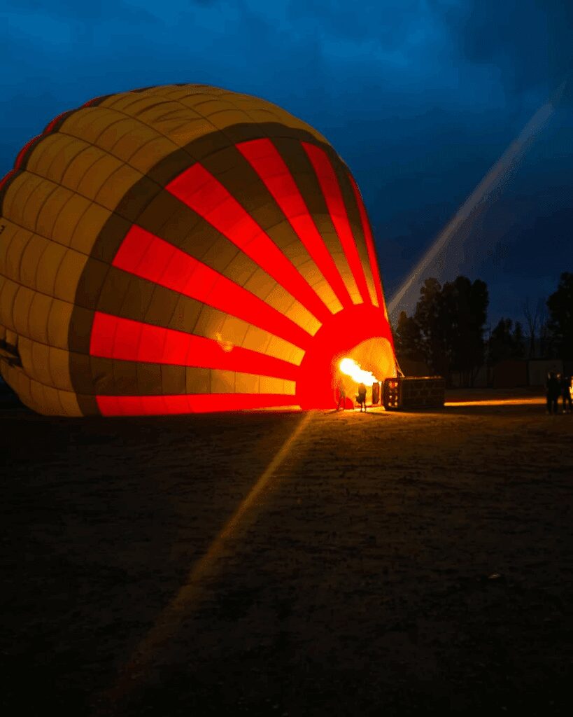 Hot air balloon being inflated before sunrise in Marrakech