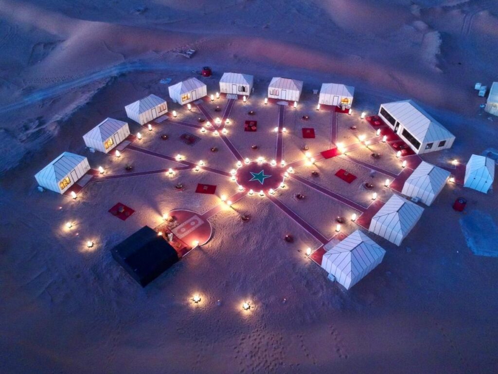 Aerial view of illuminated desert camp in Sahara at night
