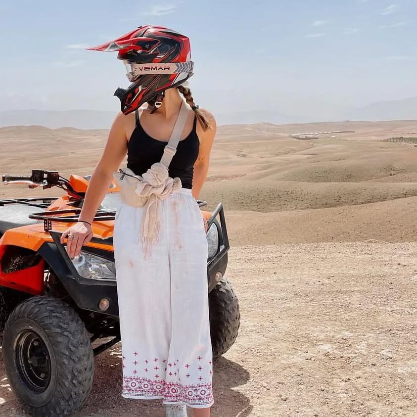 Female traveler preparing for quad ride in Marrakech desert