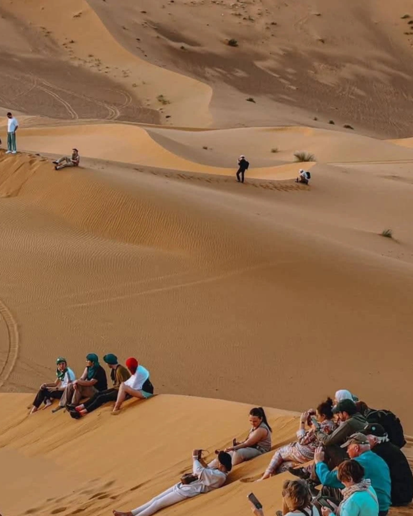 Golden sunrise over Erg Chebbi dunes in Merzouga, morning of Day 3 on luxury Sahara tour from Marrakech
