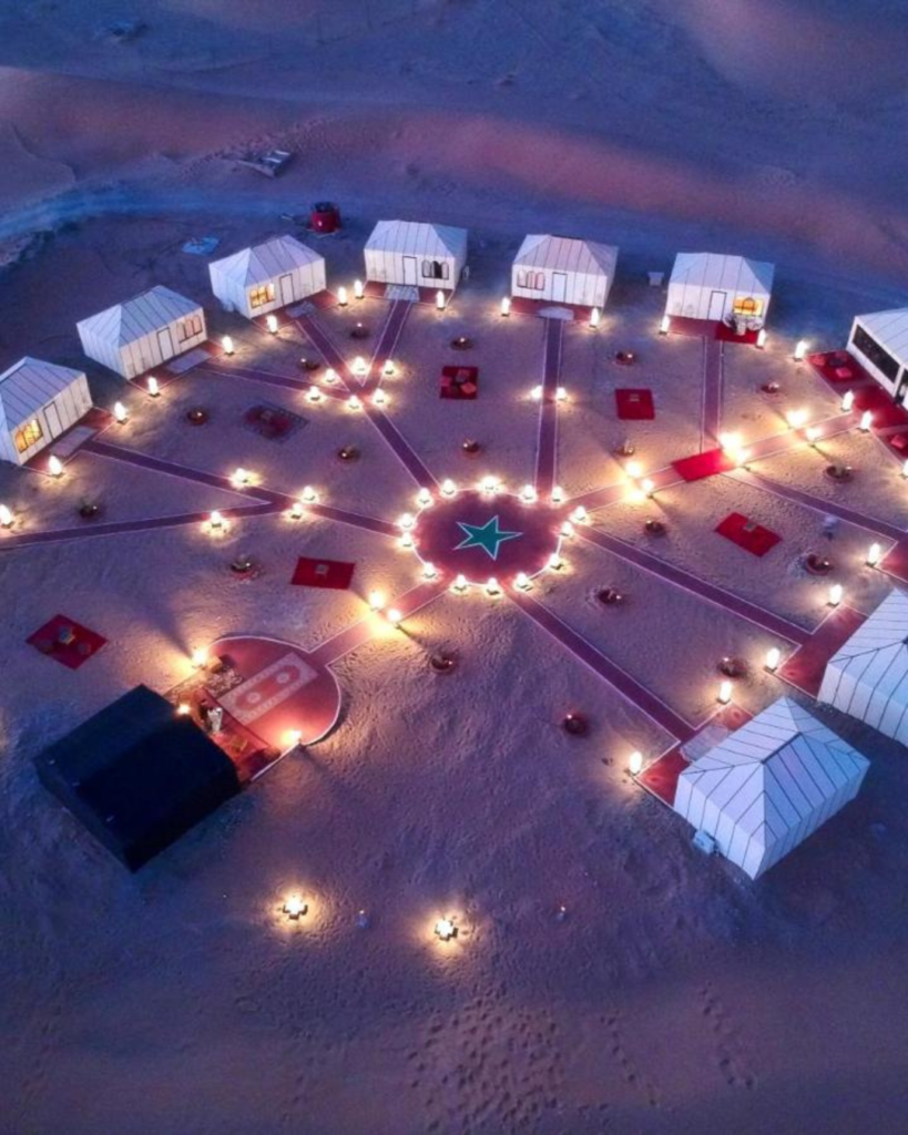 Elegant luxury desert camp under starry sky in Merzouga, included in Marrakech Sahara tour