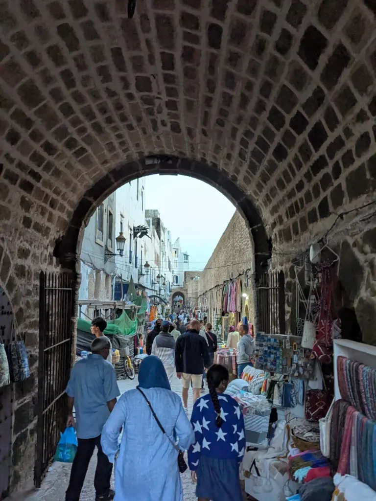 A street under a stone arch in the Essaouira medina