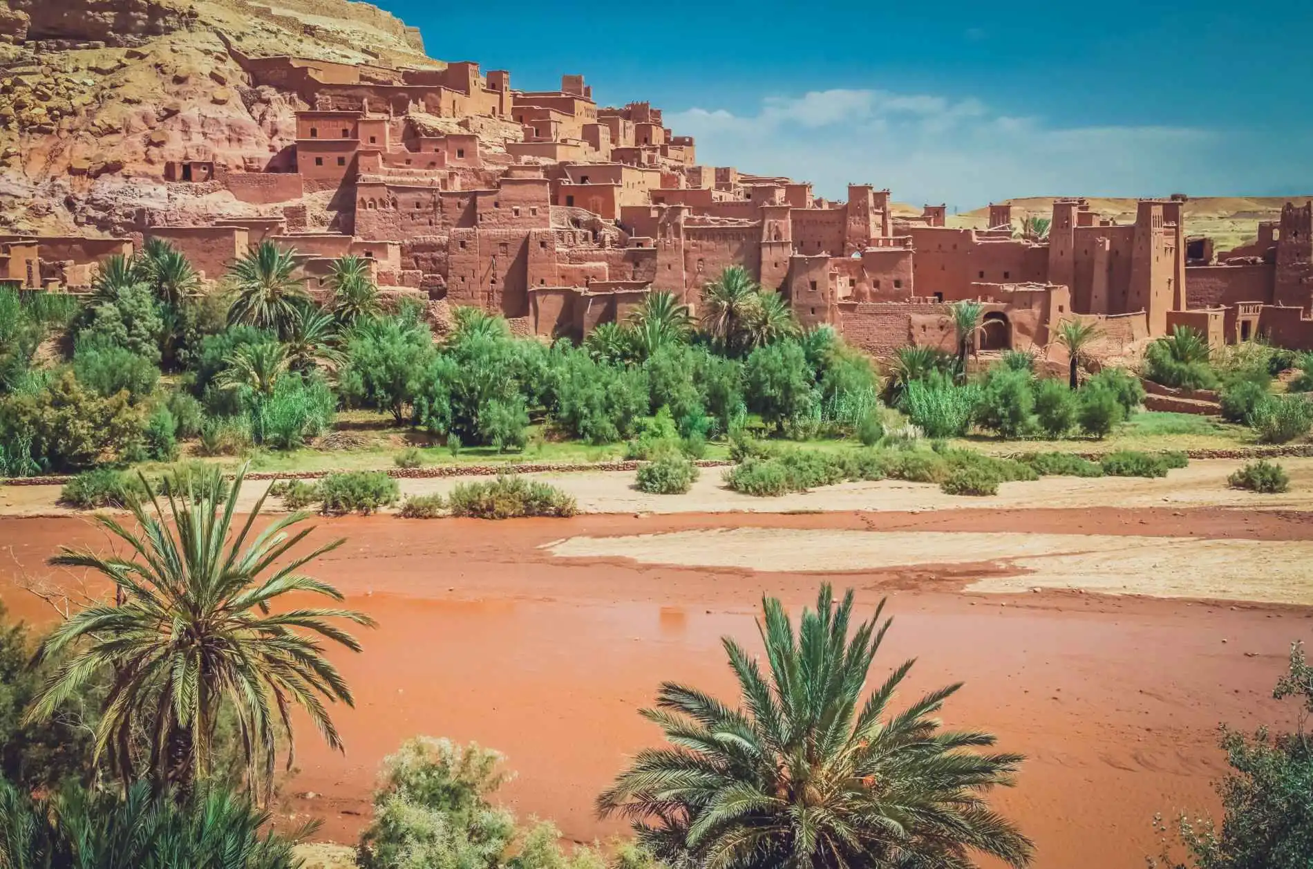 The earthen kasbah of Ait Ben Haddou above its palm-lined river, Morocco