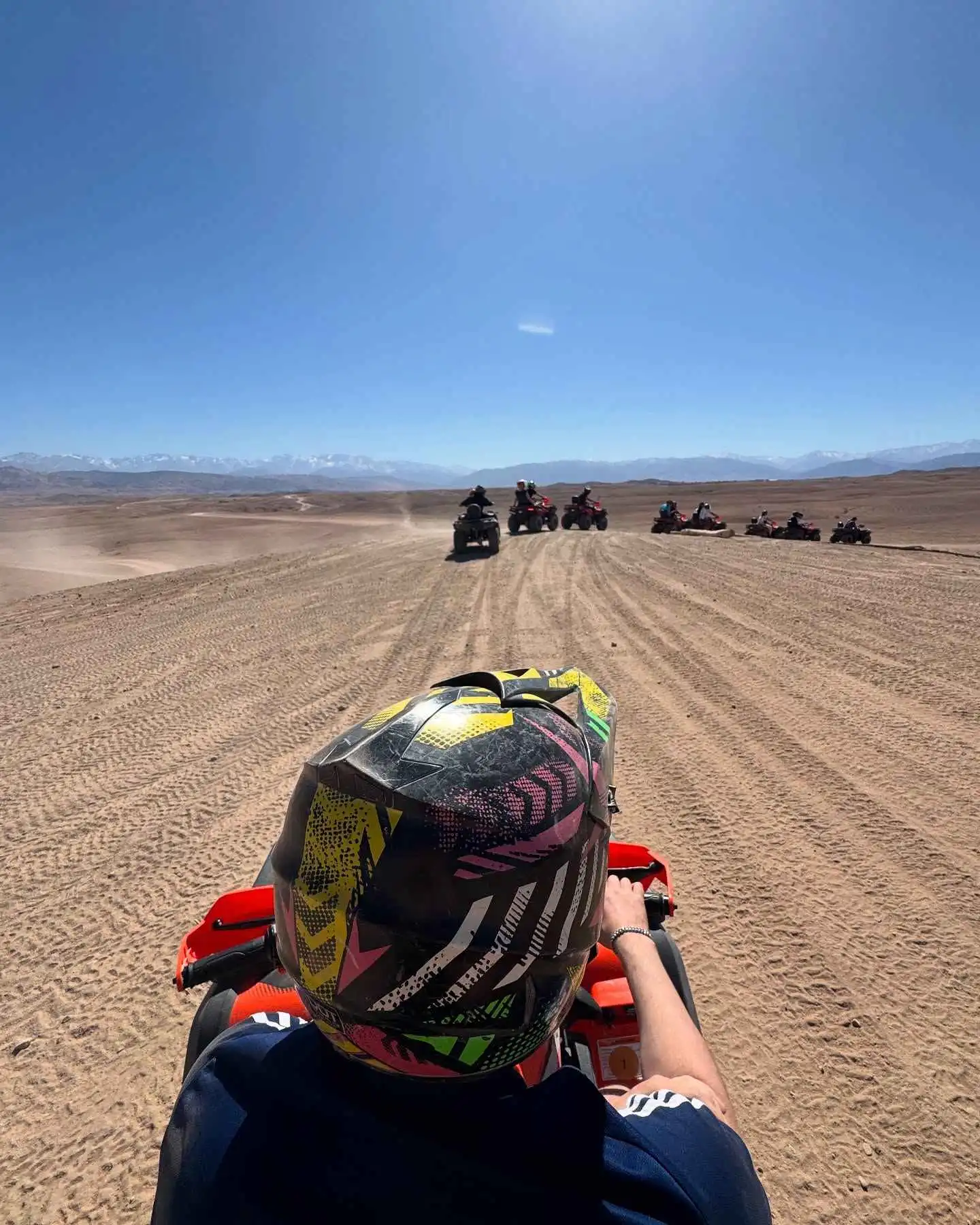 Marrakech ATV & Quad Biking Tour 5 Travellers quad biking with a guide on a desert trail near Marrakech