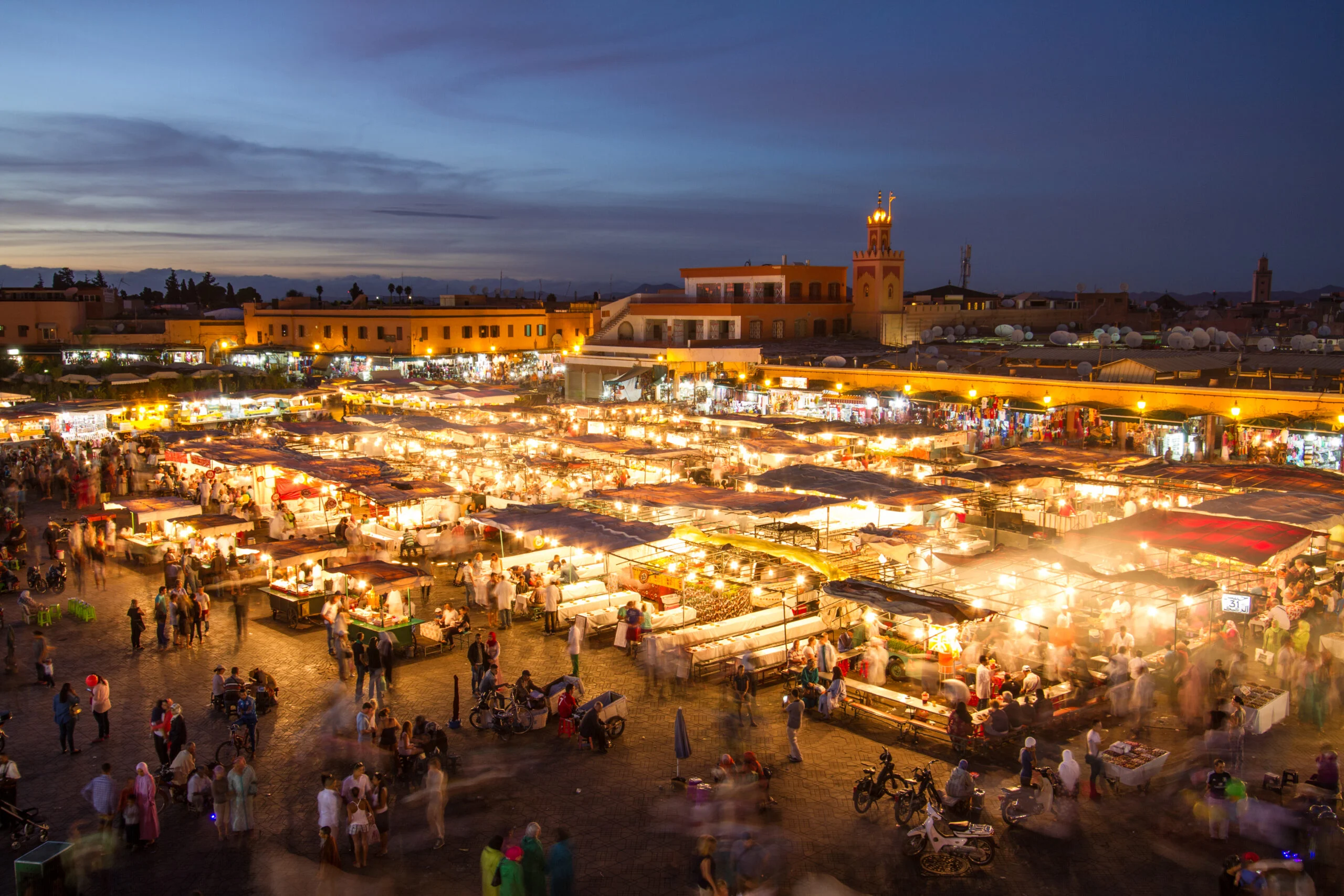 Jemaa el-Fna square in Marrakech at dusk, where the evening street food stalls set up