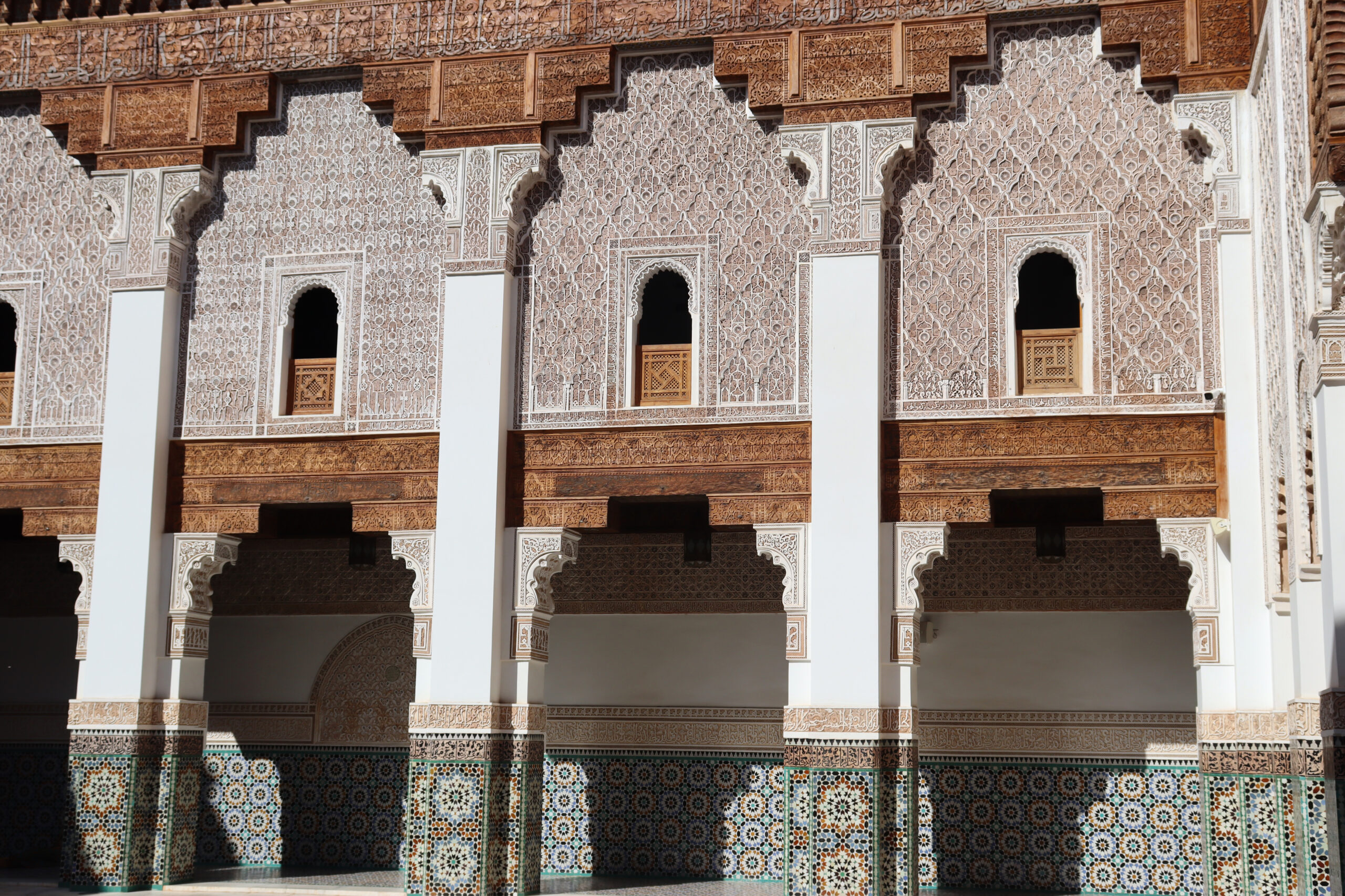 Carved cedar, stucco and zellige around the courtyard of the Ben Youssef Madrasa in Marrakech